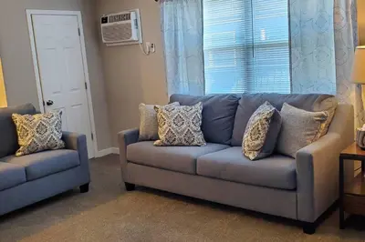 a living room with a blue couch and a window at 219 Maxwell St Unit B Such a great place to work and stay in Franklin