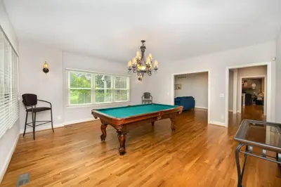 a living room with a pool table in it at 5755 Butler Warren Cheerful 6-Bedroom Villa with fishing pond in Jericho