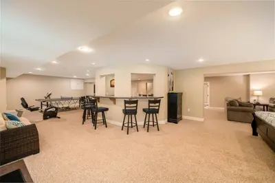 a living room with a couch and a table and chairs at 5755 Butler Warren Cheerful 6-Bedroom Villa with fishing pond in Jericho
