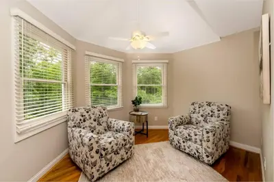 a living room with two chairs and a ceiling fan at 5755 Butler Warren Cheerful 6-Bedroom Villa with fishing pond in Jericho