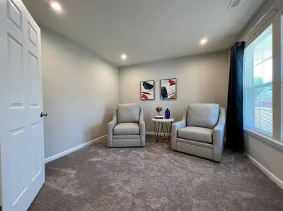 two chairs and a table in a room with a window at 7876 Ellington Court Cheerful 4 Bedroom Home Brand New Construction in Maineville