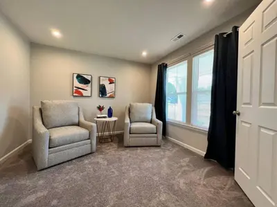 two chairs and a table in a room with a window at 7876 Ellington Court Cheerful 4 Bedroom Home Brand New Construction in Maineville