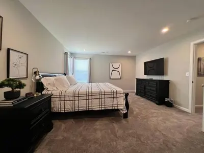 a bedroom with a bed and a television in it at 7876 Ellington Court Cheerful 4 Bedroom Home Brand New Construction in Maineville