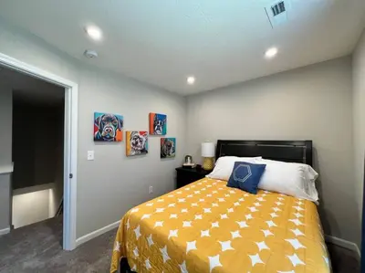 a bedroom with a bed and paintings on the wall at 7876 Ellington Court Cheerful 4 Bedroom Home Brand New Construction in Maineville