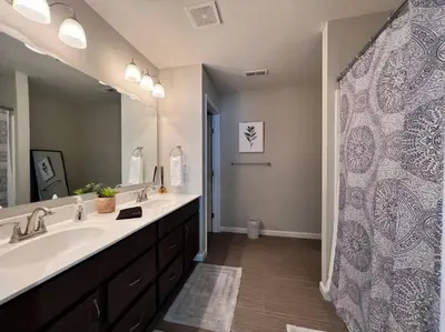 a bathroom with a sink and a large mirror at 7876 Ellington Court Cheerful 4 Bedroom Home Brand New Construction in Maineville