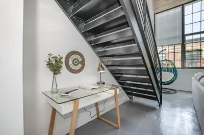 a desk in a room with a staircase at 5103 Peters New Industrial Loft on Lebanon Bike Trail in Maineville