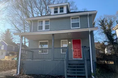 a gray house with a red door and a red door at 3311 Evanston Large Renovated 4 BDR Close to DTWN Laundry in Cincinnati