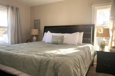 a bedroom with a large bed with white pillows at 3311 Evanston Large Renovated 4 BDR Close to DTWN Laundry in Cincinnati