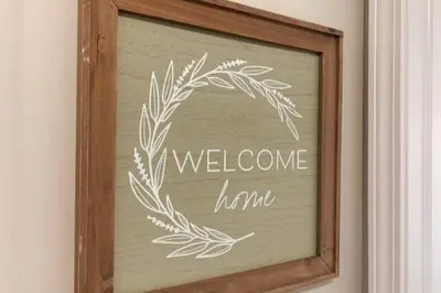 a welcome frame with a wreath on a wall at 3311 Evanston Large Renovated 4 BDR Close to DTWN Laundry in Cincinnati