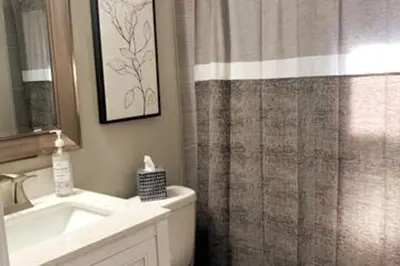 a bathroom with a sink and a shower curtain at 3311 Evanston Large Renovated 4 BDR Close to DTWN Laundry in Cincinnati