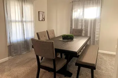 a dining room table with chairs and a bowl of plants on it at 3311 Evanston Large Renovated 4 BDR Close to DTWN Laundry in Cincinnati