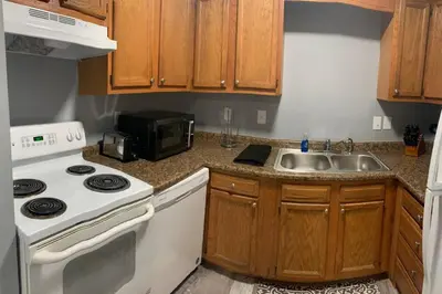 a kitchen with a white stove and a sink at 5145 Porsche Newly Remodeled 2 BDRM Ranch Attached Home in Rockdale
