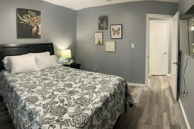 a bedroom with a bed with a comforter on it at 5145 Porsche Newly Remodeled 2 BDRM Ranch Attached Home in Rockdale