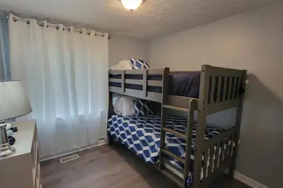 a small bedroom with a bunk bed and a desk at 1349 Jennings court Private Pool, Fire pit, BBQ A FUN place to RELAX in Mason