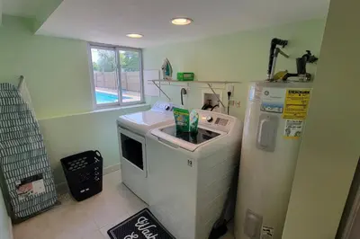 a kitchen with a washing machine and a washer at 1349 Jennings court Private Pool, Fire pit, BBQ A FUN place to RELAX in Mason