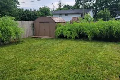 a backyard with a fence and a shed at 1349 Jennings court Private Pool, Fire pit, BBQ A FUN place to RELAX in Mason