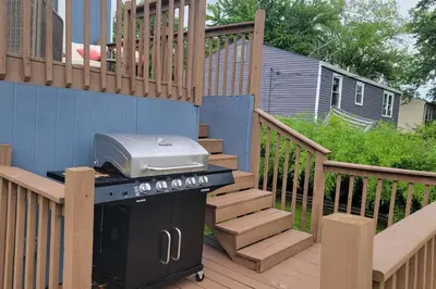 a grill sitting on a deck next to a staircase at 1349 Jennings court Private Pool, Fire pit, BBQ A FUN place to RELAX in Mason