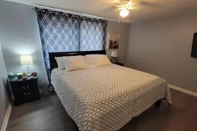 a bedroom with a large bed with a blue headboard at 1349 Jennings court Private Pool, Fire pit, BBQ A FUN place to RELAX in Mason