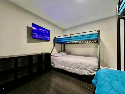 a bedroom with two bunk beds and a tv on the wall at 190 Overbrook Drive Swanky Swangos Dream Home by Jess in Monroe