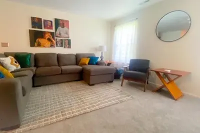 a living room with a couch and a mirror at 240 Overbrook NEW Franks funky and fashionable furnished home in Monroe