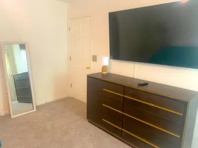 a dresser in a room with a large mirror at 240 Overbrook NEW Franks funky and fashionable furnished home in Monroe