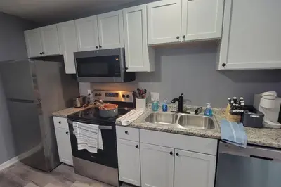 a kitchen with white cabinets and a sink at 160 Overbrook 3 bedroom home with privately fenced yard and hot tub in Monroe