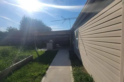 a walkway next to a building with the sun behind it at 160 Overbrook 3 bedroom home with privately fenced yard and hot tub in Monroe