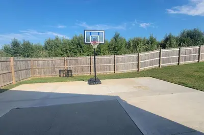 a basketball hoop in a backyard with a fence at 160 Overbrook 3 bedroom home with privately fenced yard and hot tub in Monroe