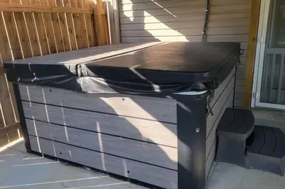 a wooden table sitting on the side of a house at 160 Overbrook 3 bedroom home with privately fenced yard and hot tub in Monroe