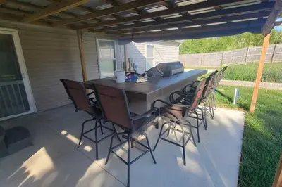 a table and chairs sitting on a patio at 160 Overbrook 3 bedroom home with privately fenced yard and hot tub in Monroe