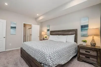 a bedroom with a bed and a table with a lamp at 950 Southline Newly Built Home in Lebanon 4 BDR 2 5 Bath in Lebanon