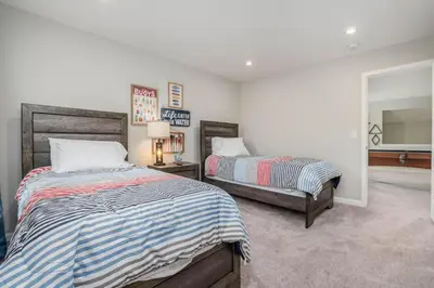 a bedroom with two beds and a mirror at 950 Southline Newly Built Home in Lebanon 4 BDR 2 5 Bath in Lebanon