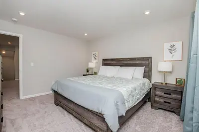 a bedroom with a large bed and two night stands at 950 Southline Newly Built Home in Lebanon 4 BDR 2 5 Bath in Lebanon
