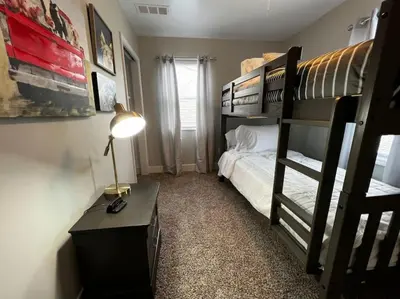 a bedroom with a bunk bed and a desk with a lamp at 956 Olympia Drive Brand New Mason Home with Luxurious Finishes in Mason