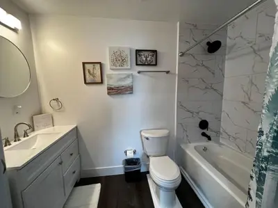 a bathroom with a toilet and a sink and a tub at 956 Olympia Drive Brand New Mason Home with Luxurious Finishes in Mason