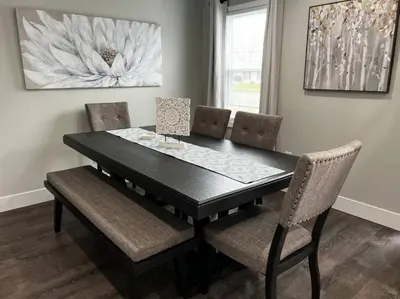 a dining room with a black table and chairs at 956 Olympia Drive Brand New Mason Home with Luxurious Finishes in Mason