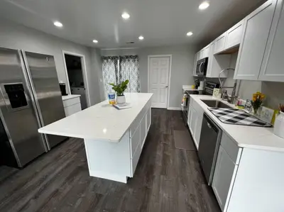a large kitchen with white counters and stainless steel appliances at 956 Olympia Drive Brand New Mason Home with Luxurious Finishes in Mason