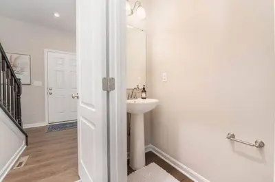 a white bathroom with a sink and a mirror at 1344 soaring way NEW Cheerful 5 bedroom home in quiet suburban area in Maineville