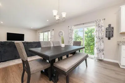 a dining room with a table and a couch at 1344 soaring way NEW Cheerful 5 bedroom home in quiet suburban area in Maineville