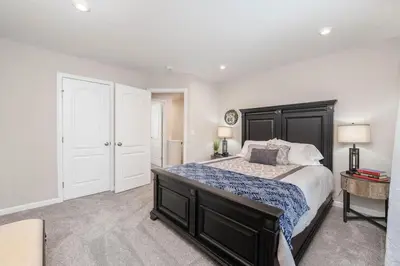 a bedroom with a large bed and white walls at 1344 soaring way NEW Cheerful 5 bedroom home in quiet suburban area in Maineville