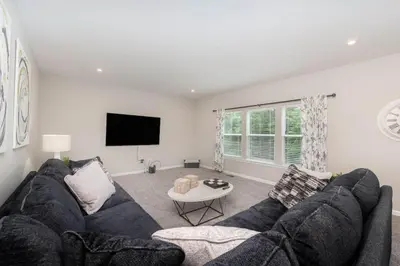 a living room with a couch and a tv at 1344 soaring way NEW Cheerful 5 bedroom home in quiet suburban area in Maineville