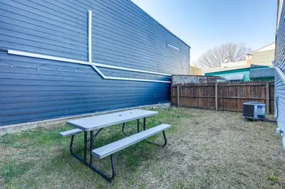 a picnic table and a bench in front of a blue wall at Cozy Newport Cottage Near Stadiums and Downtown in Newport