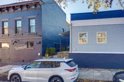 a white car parked in front of a house at Cozy Newport Cottage Near Stadiums and Downtown in Newport