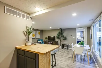 a kitchen and living room with a table and chairs at Cozy Newport Cottage Near Stadiums and Downtown in Newport
