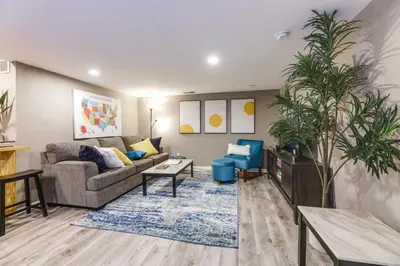 a living room with a couch and a table at Cozy Newport Cottage Near Stadiums and Downtown in Newport