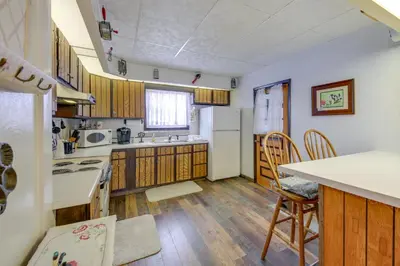 a kitchen with wooden floors and a white refrigerator at Historic Alexandria Home with Private Yard! in Alexandria