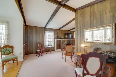 a living room with wooden walls and chairs and a table at Historic Alexandria Home with Private Yard! in Alexandria