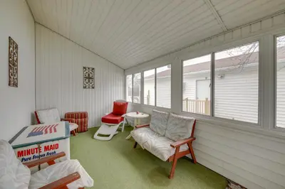 a screened in porch with chairs and a table at Historic Alexandria Home with Private Yard! in Alexandria