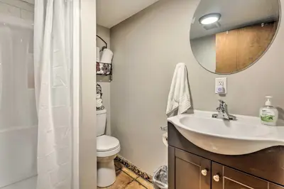 a bathroom with a sink and a toilet and a mirror at Peaceful Mt Sterling Cabin Deck and Fire Pit! in Mount Sterling