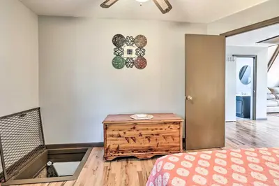 a bedroom with a bed and a wooden table at Peaceful Mt Sterling Cabin Deck and Fire Pit! in Mount Sterling